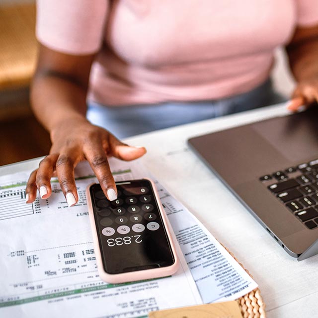 Woman using the calculator on her phone