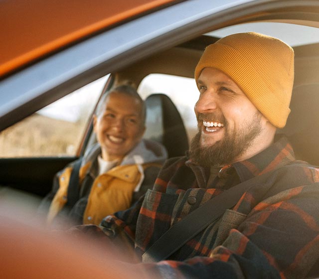 Couple in the car smiling.