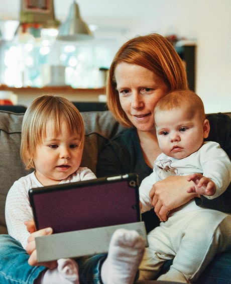 mom and babies with tablet at home