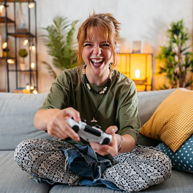 Girl on the couch playing video games