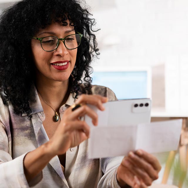 Woman taking a photo of a check