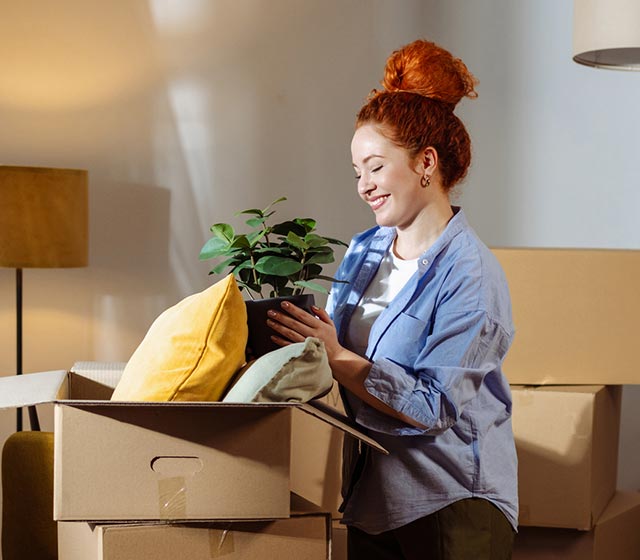 Woman unpacking boxes in a new home.