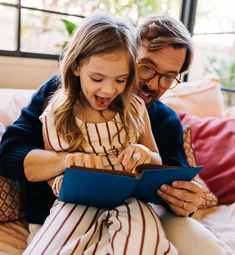 dad and girl reading