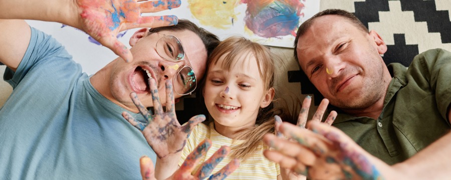 Two men and daughter with paint on them